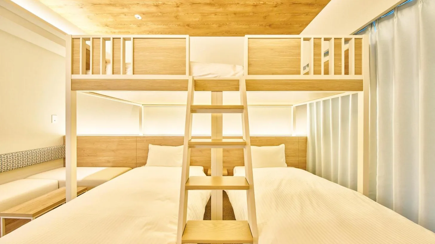 a small bedroom with bunk beds and a ladder at 2026年7月New Open! Grand STAY Hakata Nishinakasu in Fukuoka