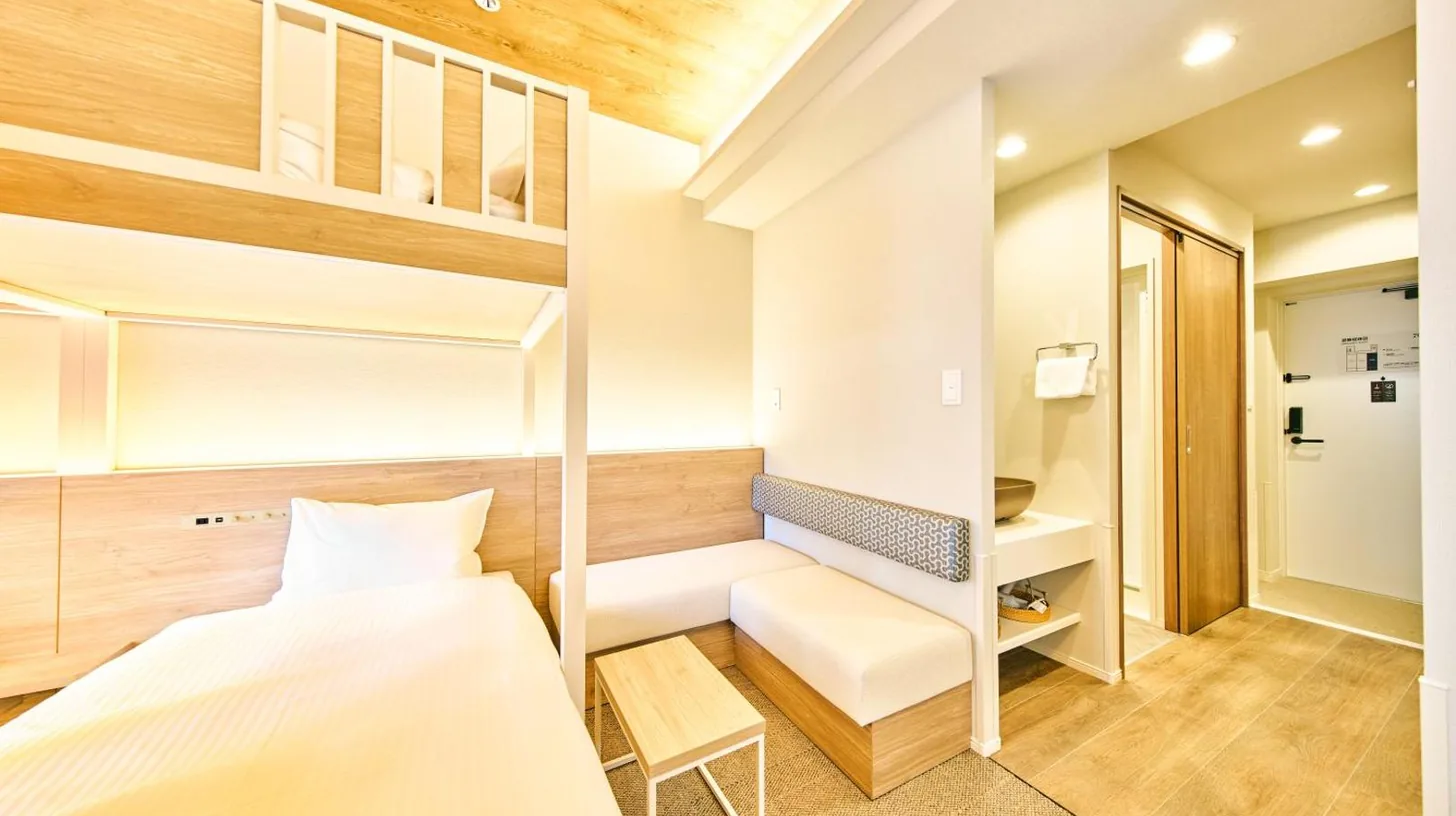 a bedroom with two bunk beds and a ladder at 2026年7月New Open! Grand STAY Hakata Nishinakasu in Fukuoka