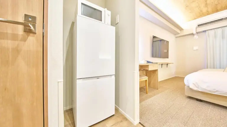 a microwave oven sitting on top of a cabinet at 2026年7月New Open! Grand STAY Hakata Nishinakasu in Fukuoka