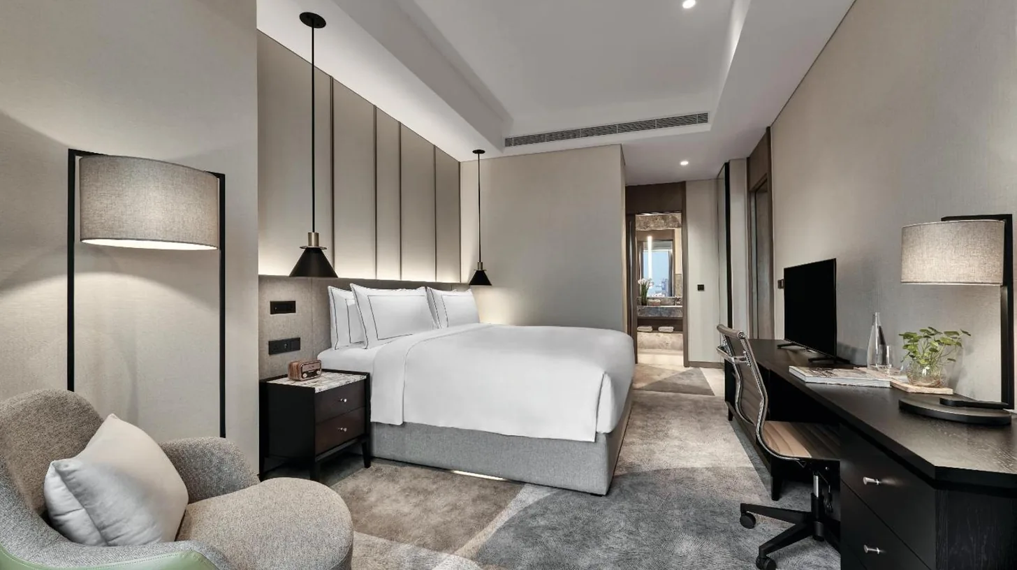 a hotel room with a bed and a desk at 25hours Hotel Jakarta The Oddbird in Jakarta