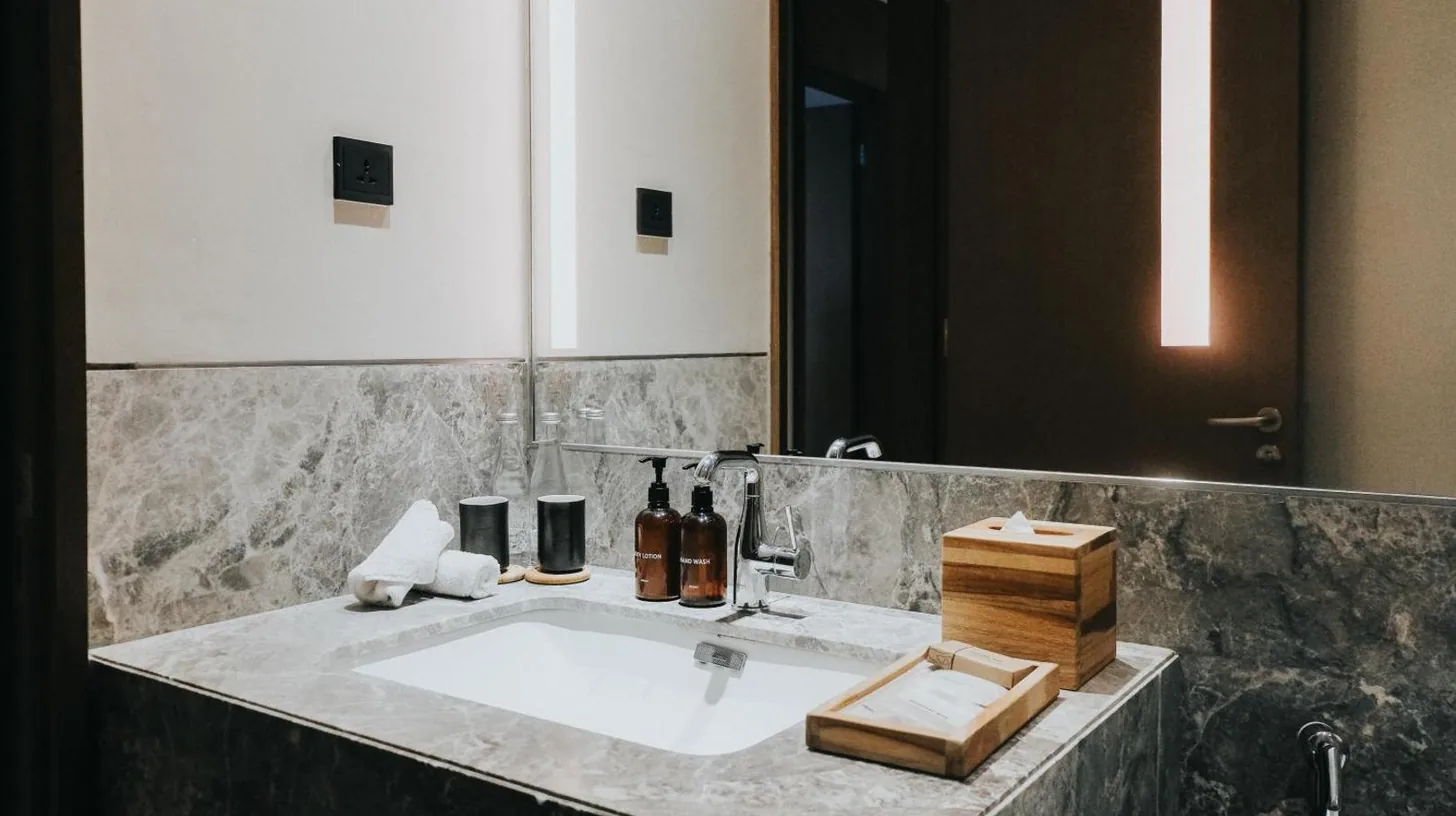 a bedroom with a large bed and a living room at 25hours Hotel Jakarta The Oddbird in Jakarta