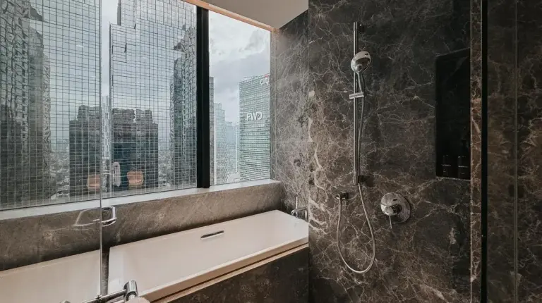 a large living room with a large white bed and a living room at 25hours Hotel Jakarta The Oddbird in Jakarta