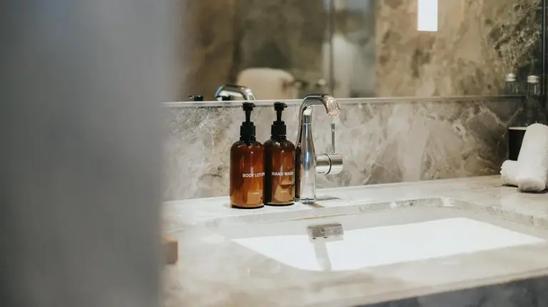 a bathroom with two sinks and a large mirror at 25hours Hotel Jakarta The Oddbird in Jakarta