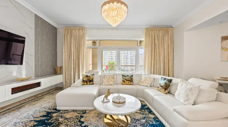 a living room with a white couch and a table at 2BDR Luxury Apartment in Palm in Dubai