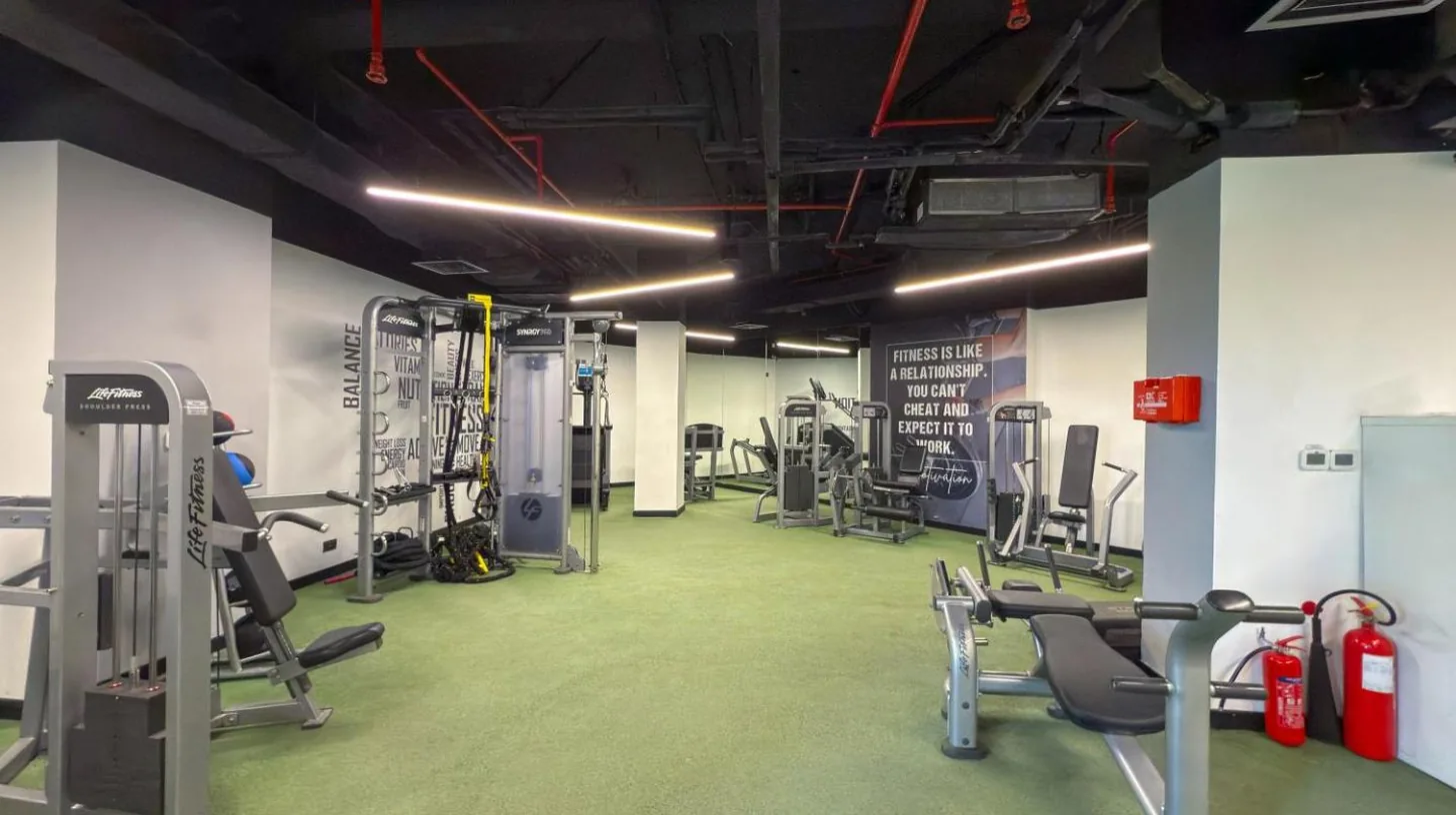 a gym with several treadmills and machines in it at 2BDR Luxury Apartment in Palm in Dubai