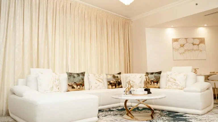 a living room with two white couches and a table at 2BDR Luxury Apartment in Palm in Dubai