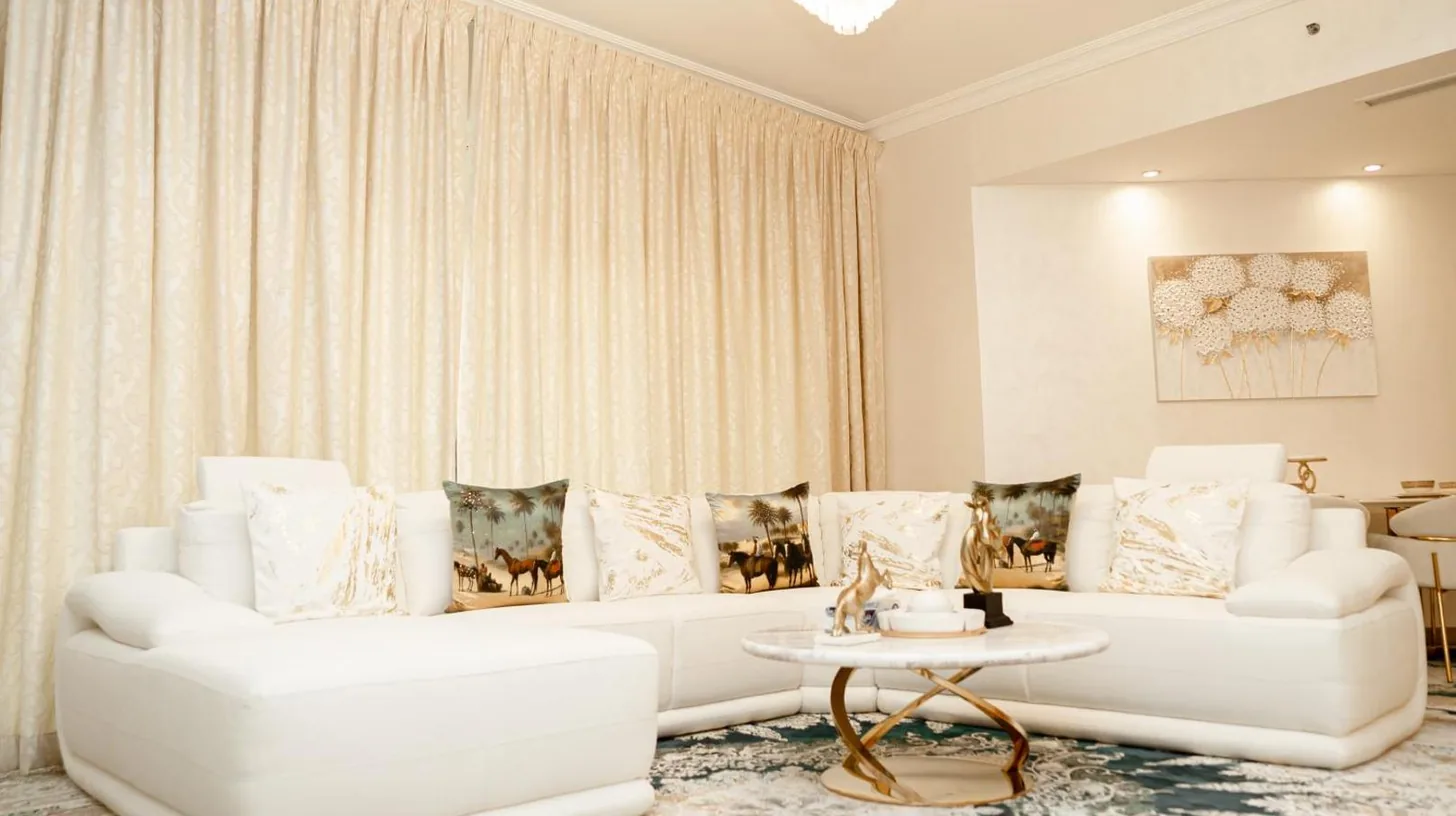 a living room with two white couches and a table at 2BDR Luxury Apartment in Palm in Dubai