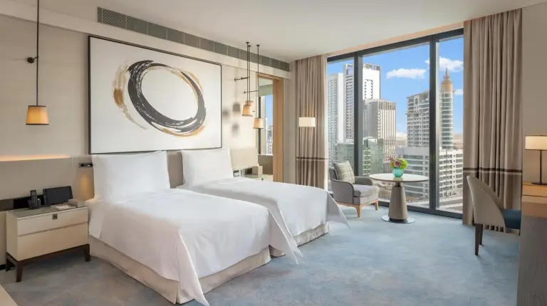 a hotel room with a bed and a large window at Address Beach Resort in Dubai