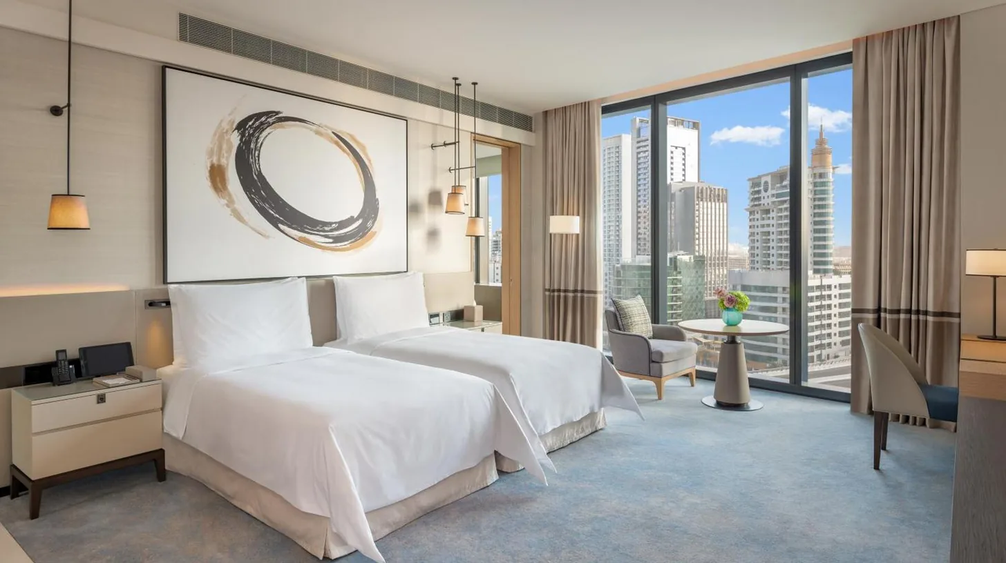 a hotel room with a bed and a large window at Address Beach Resort in Dubai