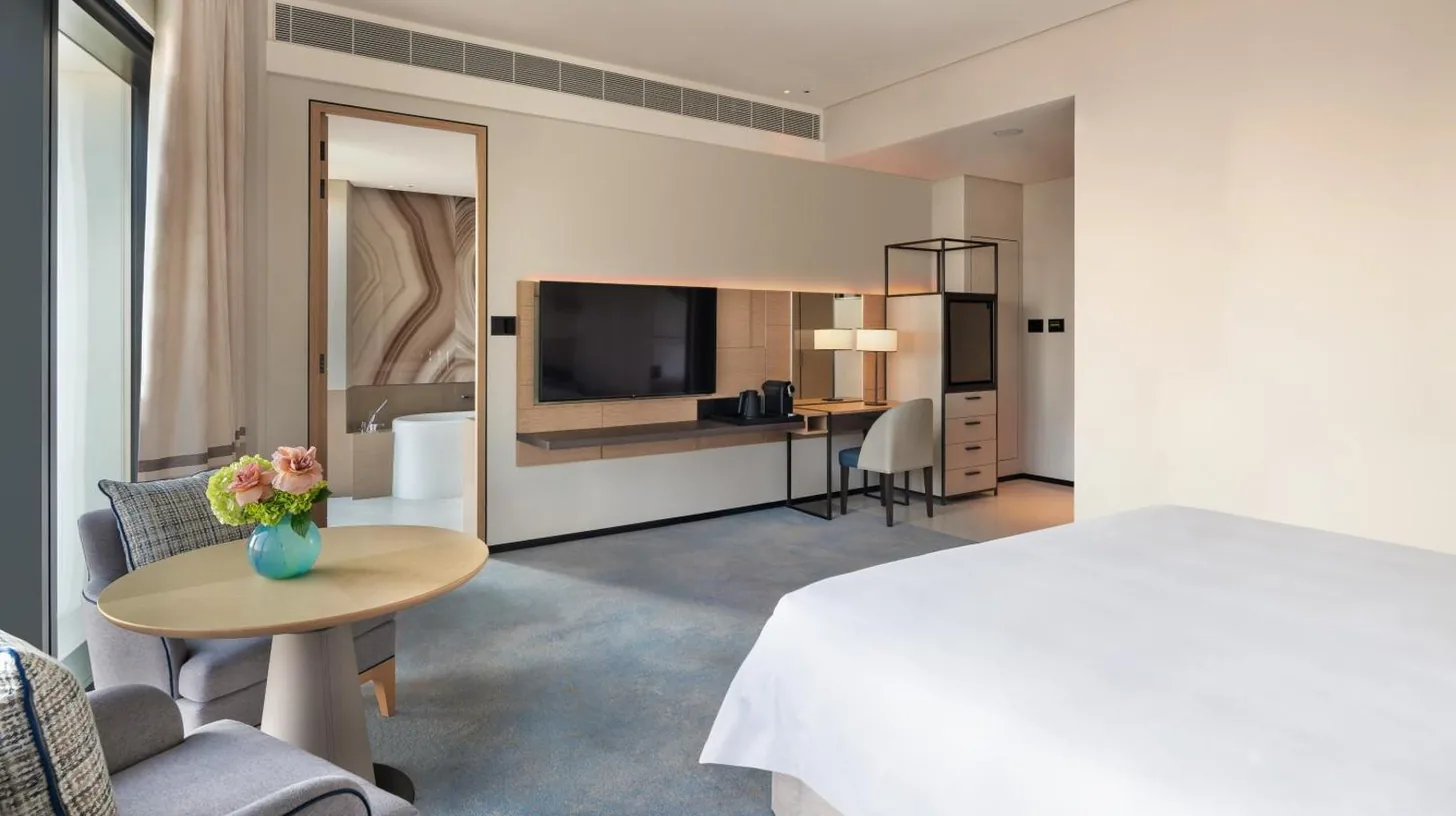 a hotel room with a bed and a table at Address Beach Resort in Dubai