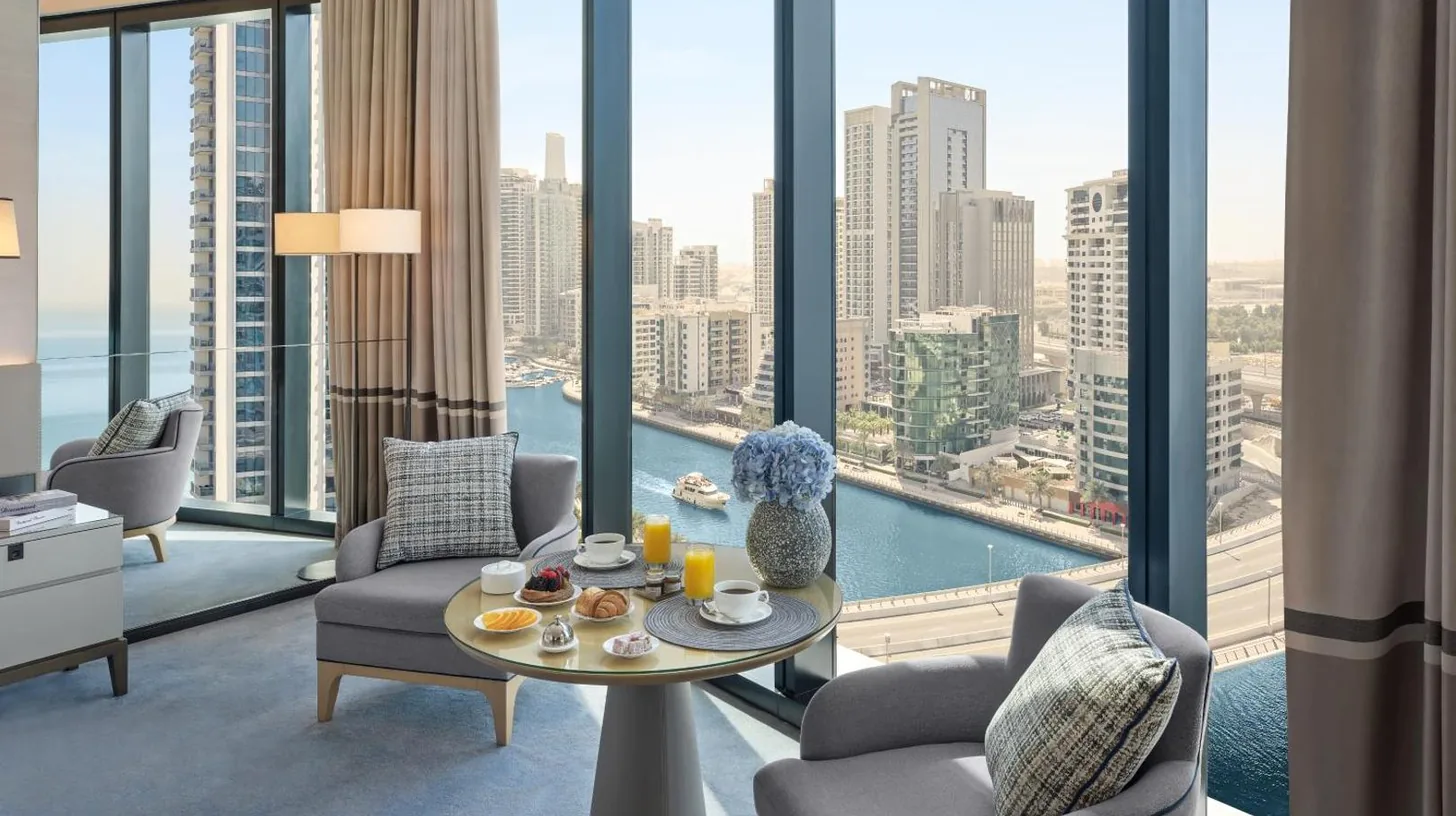 a living room with a table and chairs and a large window at Address Beach Resort in Dubai