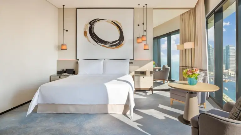 a bedroom with a bed and a living room at Address Beach Resort in Dubai