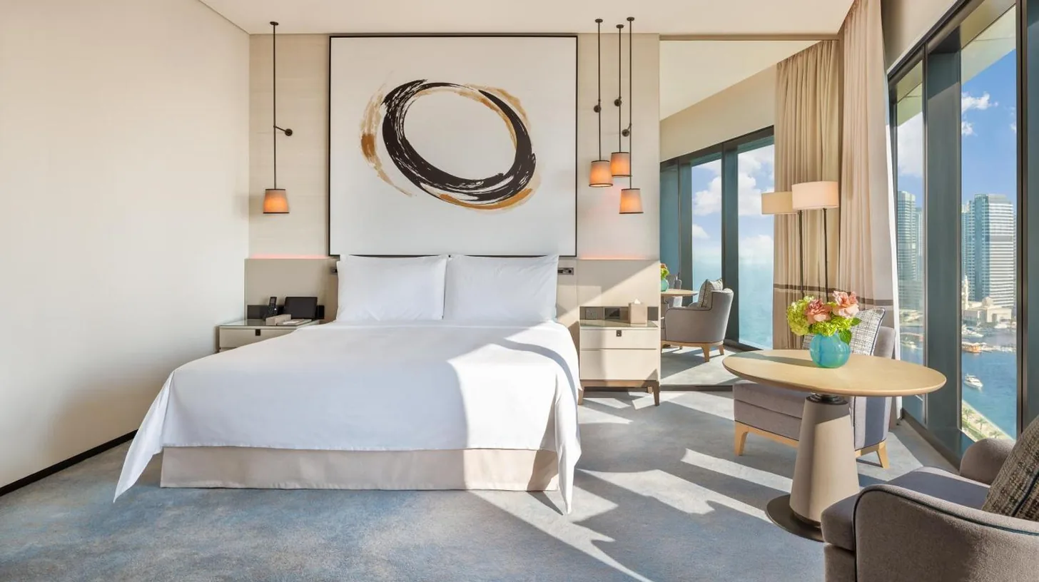 a bedroom with a bed and a living room at Address Beach Resort in Dubai