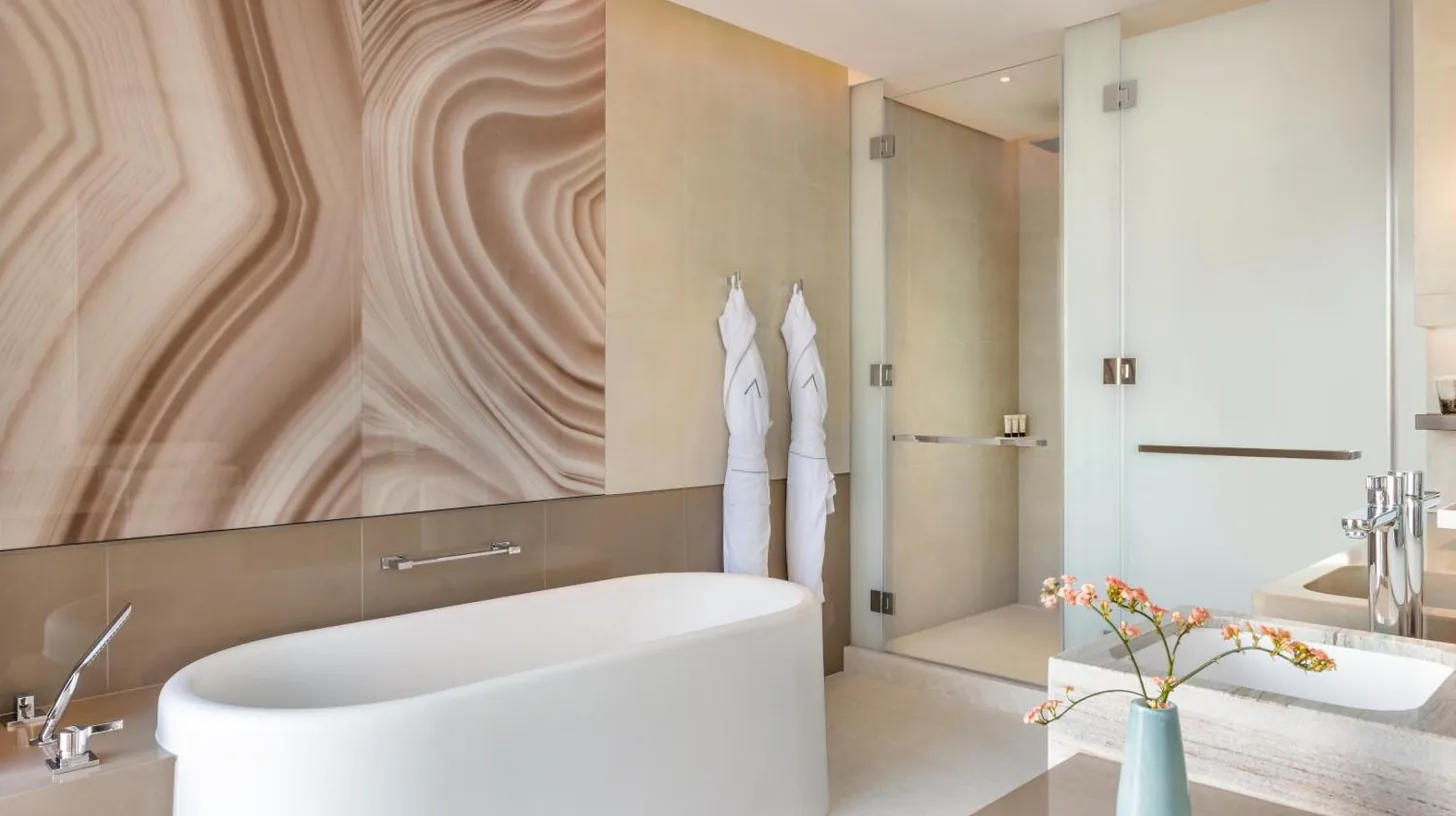 a bathroom with a large white tub and a shower at Address Beach Resort in Dubai