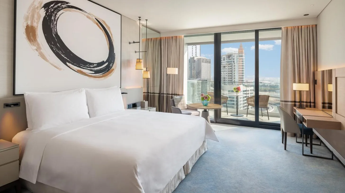 a hotel room with a large bed and a desk at Address Beach Resort in Dubai