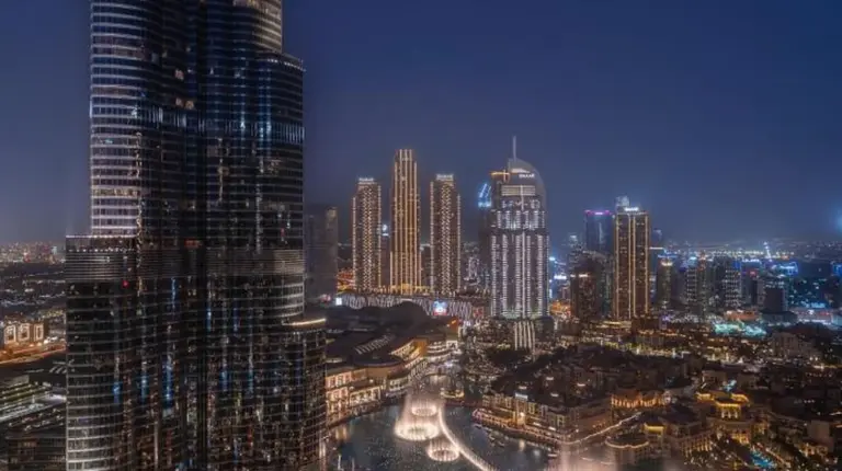 a view of a city at night with a tall building at Address Residences Dubai Opera - Burj Khalifa City Views 1