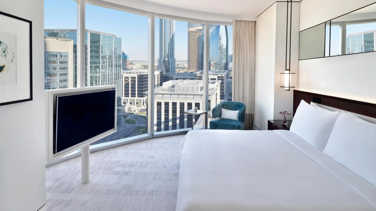a living room with a couch and a table at Address Sky View