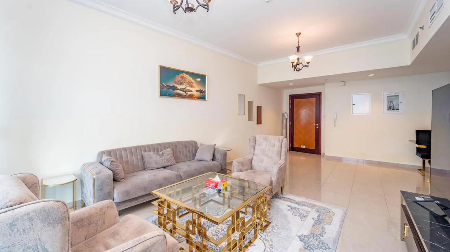 a living room with couches and a coffee table at Ajman Luxurious Holiday Homes in Ajman