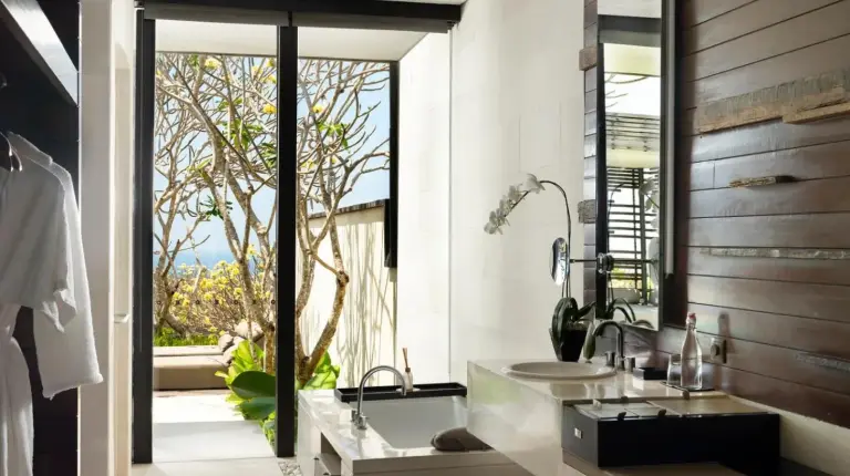 a bathroom with a sink and a large window at Alila Villas Uluwatu in Uluwatu