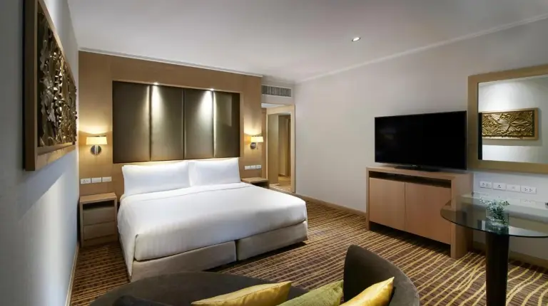 a hotel room with a bed and a tv at Amari Bangkok in Bangkok