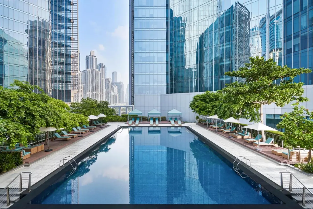 Anantara Downtown Dubai swimming pool surrounded by greenery and skyscrapers