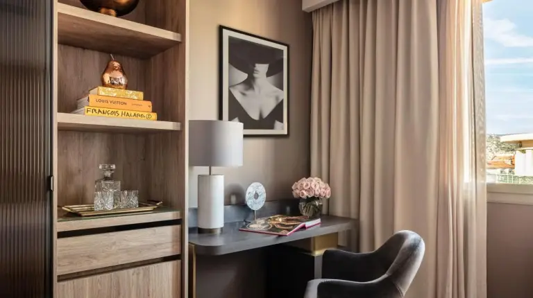 a room with a desk and a chair and a window at Anantara Plaza Nice Hotel - A Leading Hotel of the World in Nice