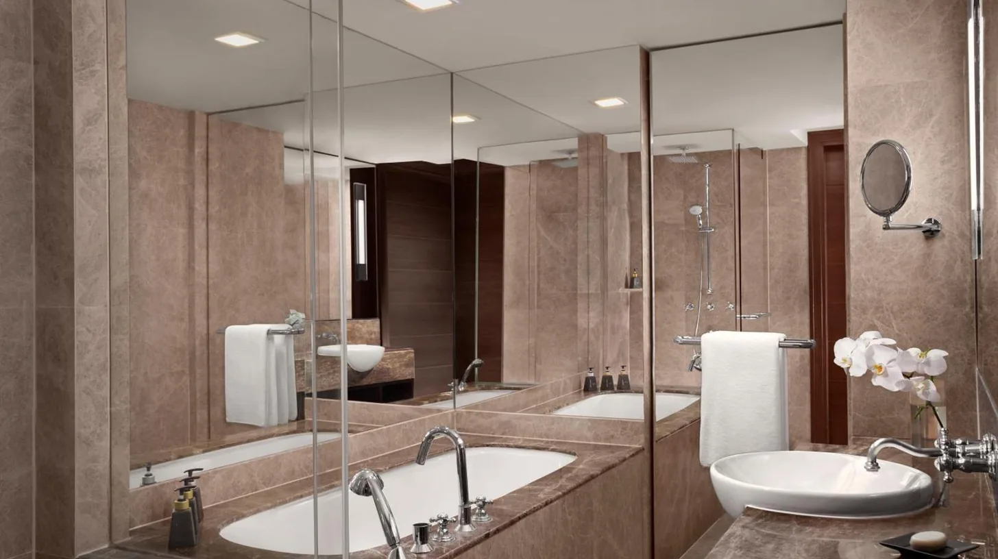 a bathroom with two sinks and a large mirror at Anantara Riverside Bangkok Resort in Bangkok