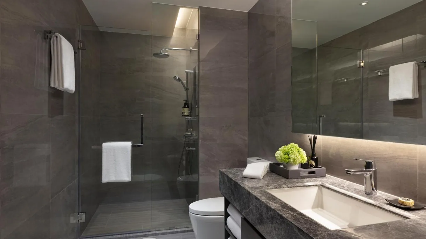 a bathroom with a sink and a shower at Ascott Embassy Sathorn Bangkok in Bangkok