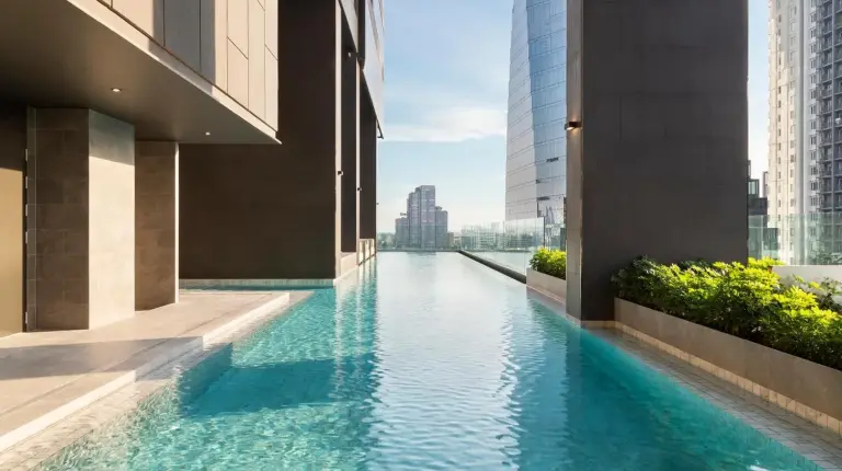 a swimming pool in the middle of a building at Ascott Thonglor Bangkok in Bangkok