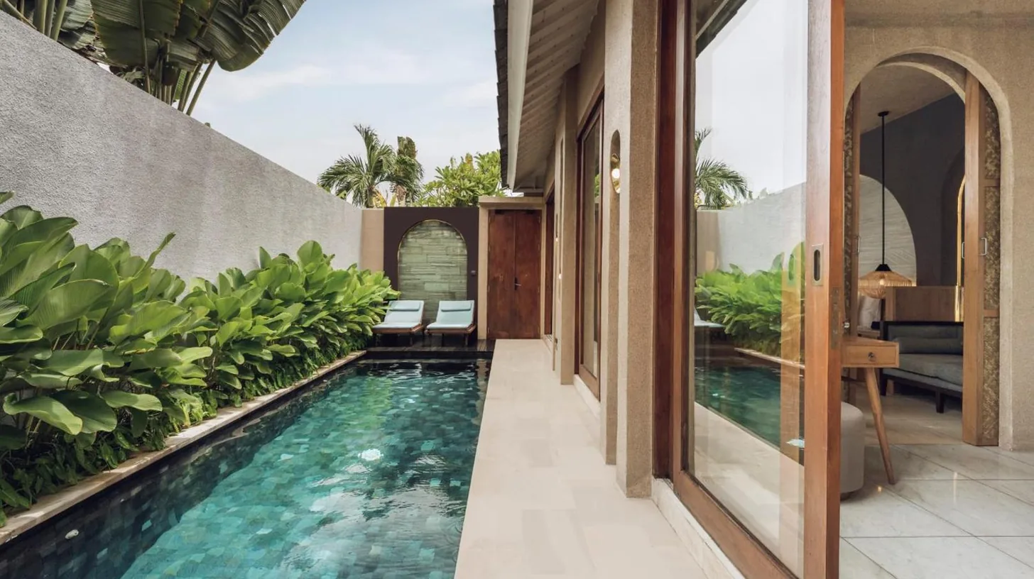 an infinity pool in the middle of a house at Astera Villa Seminyak by Ini Vie Hospitality in Seminyak