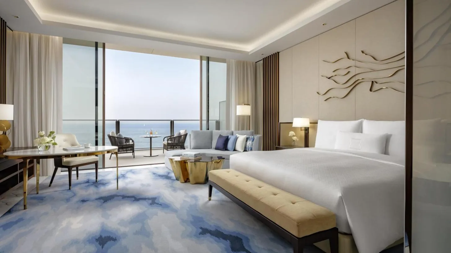 a bedroom with a bed and a living room with a view at Atlantis The Royal in Dubai
