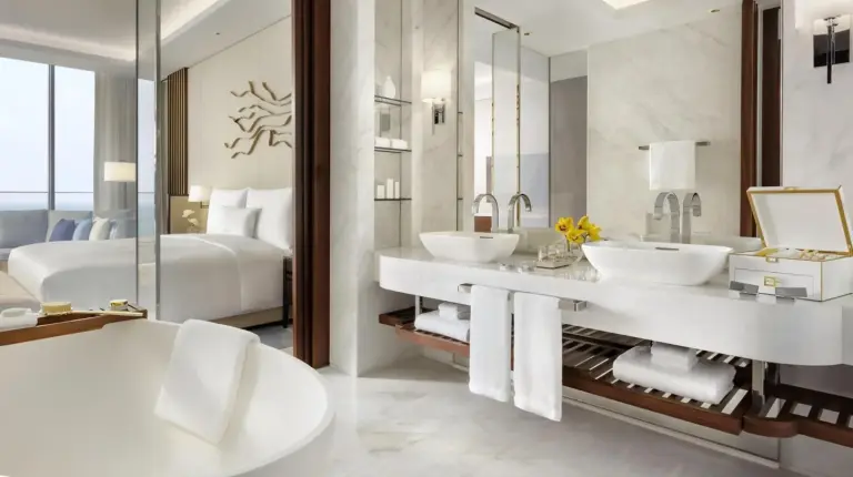 a bathroom with two sinks and a large mirror at Atlantis The Royal in Dubai