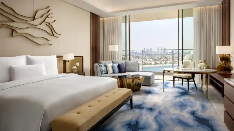 a bedroom with a large bed and a living room at Atlantis The Royal in Dubai