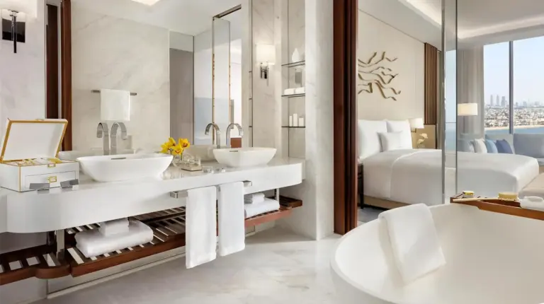 a bathroom with two sinks and a bed at Atlantis The Royal in Dubai