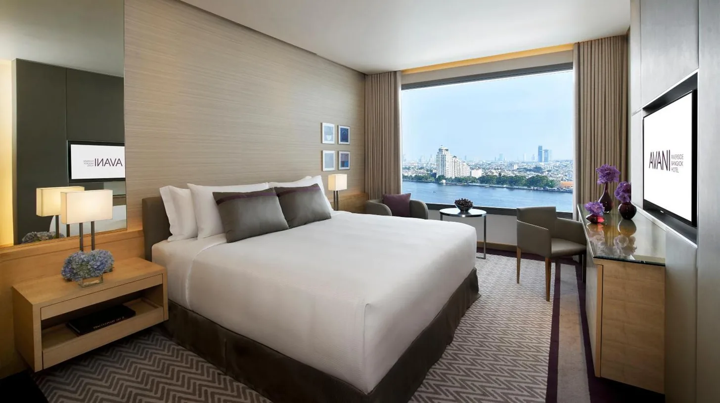 a bathroom with a white sink and a shower at Avani Plus Riverside Bangkok Hotel in Bangkok