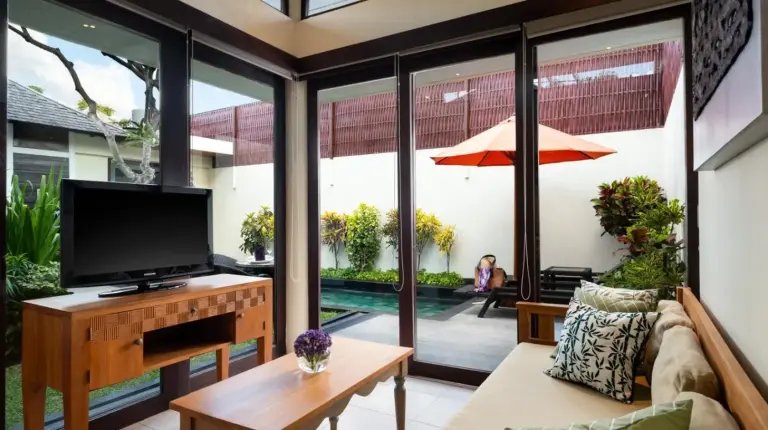 a living room with a tv and a couch at Avani Seminyak Bali Resort in Seminyak