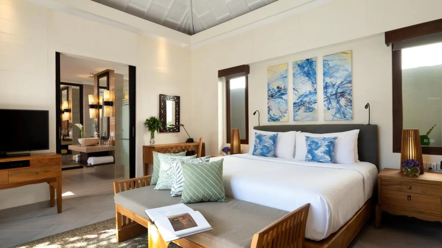 a bedroom with two beds and a tv and a window at Avani Seminyak Bali Resort in Seminyak