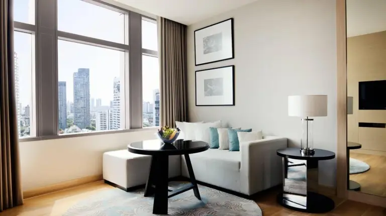 a living room with a couch and a table at Bangkok Marriott Hotel Sukhumvit in Bangkok