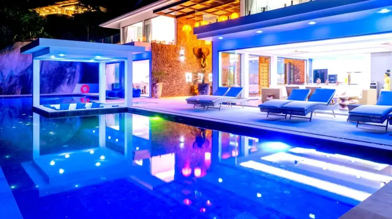 a swimming pool with blue chairs and a house at BLUE ELEPHANT Luxury Pool Villa Koh Samui in Koh Samui