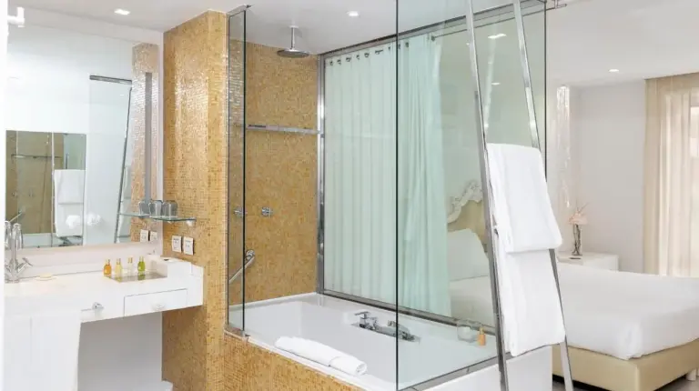 a bathroom with a glass shower and a sink at Boscolo Nice Hotel & Spa in Nice
