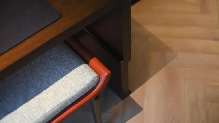 a chair sitting under a desk with a wooden table at Canopy By Hilton Bangkok Sukhumvit in Bangkok