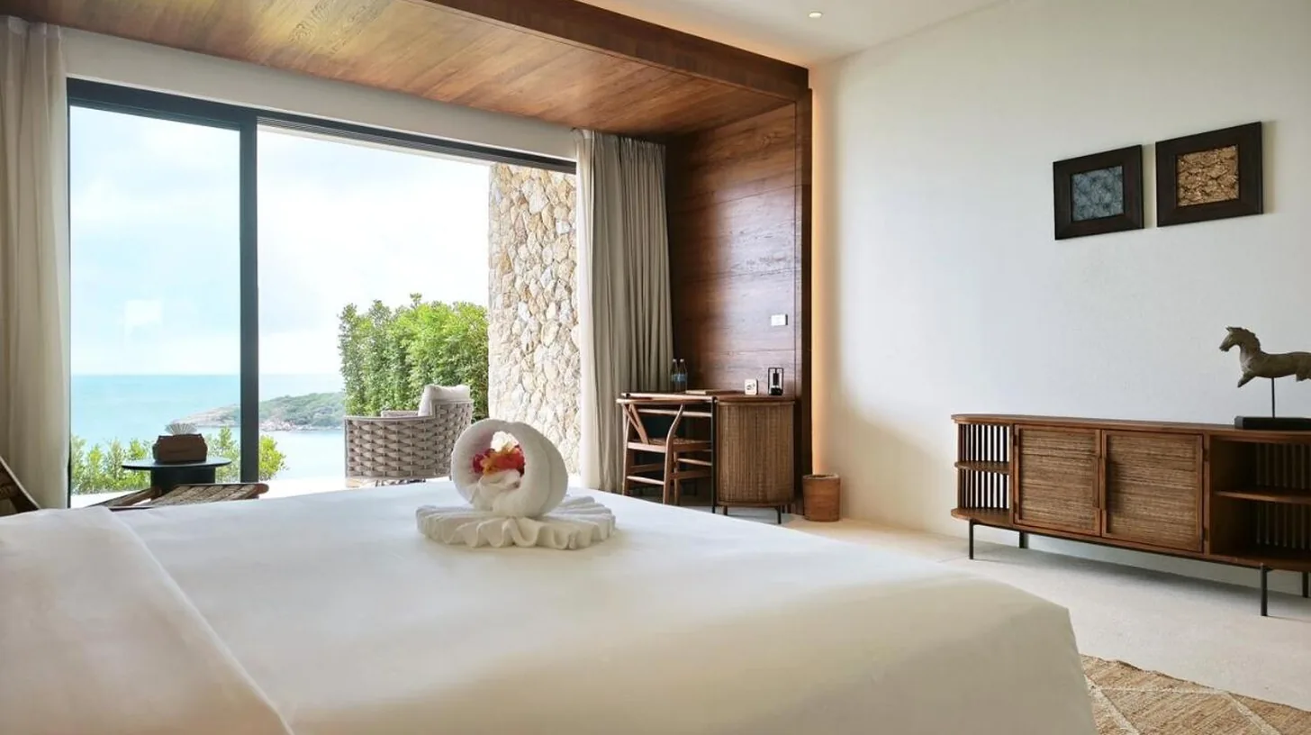 a bedroom with a large bed and a large window at Cape Azure Resort Samui by Thalsea in Plai Laem