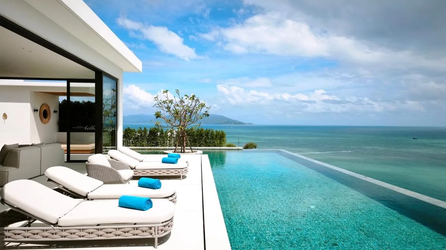 a villa with a swimming pool with a view of the ocean at Cape Azure Resort Samui by Thalsea in Plai Laem