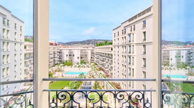two white doors with a sign that reads calcium at Carlton Cannes