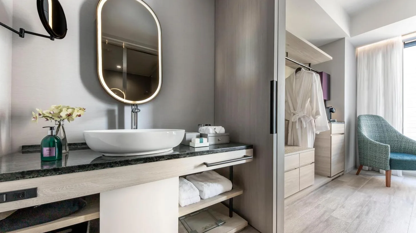 a bathroom with a sink and a mirror at Centara Grand Hotel Osaka in Osaka