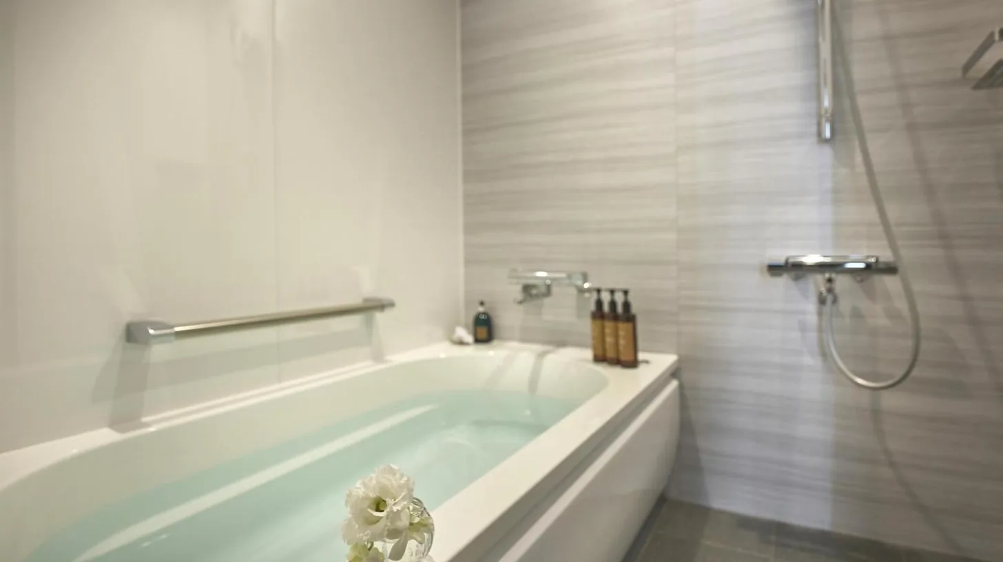 a white bathroom with a tub and a shower at Centara Grand Hotel Osaka in Osaka