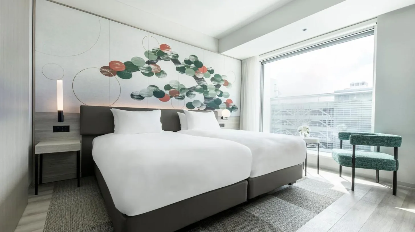 a bedroom with a large bed and a large window at Centara Grand Hotel Osaka in Osaka
