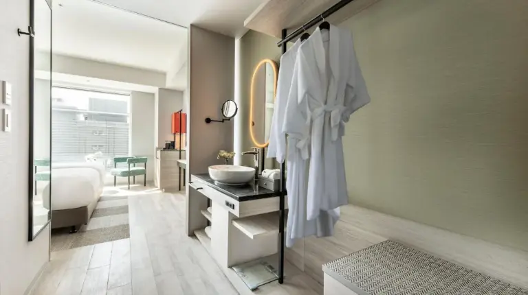 a bedroom with a large bed with a large window at Centara Grand Hotel Osaka in Osaka