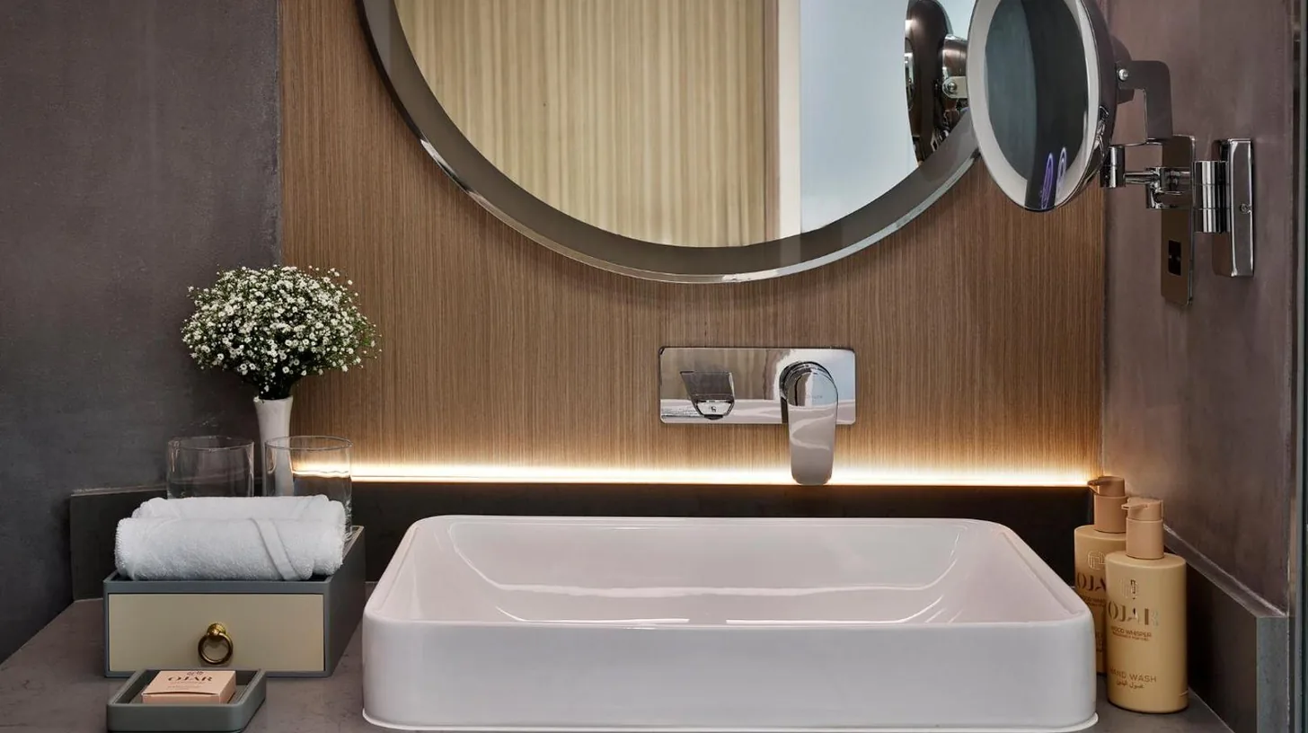 a bedroom with a white bed and a painting on the wall at Ciel Dubai Marina