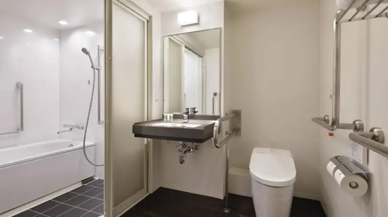 a bathroom with a sink and a toilet at Courtyard by Marriott Shin-Osaka Station in Osaka